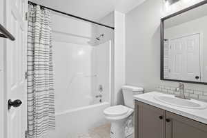 Full bathroom with tub and shower combo.