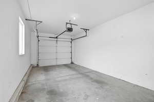 single car detached garage with a garage door opener