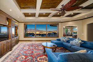 Cinema room featuring beamed ceiling, arched walkways, coffered ceiling, and recessed lighting