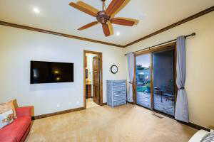 Living room with crown molding, ceiling fan, recessed lighting, and carpet floors