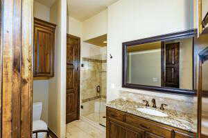 Full bathroom featuring a stall shower, vanity, and light tile patterned floors