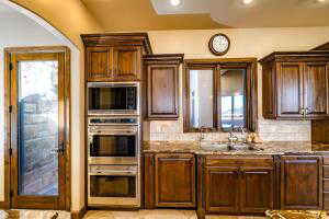 Kitchen with appliances with stainless steel finishes, arched walkways, recessed lighting, and tasteful backsplash