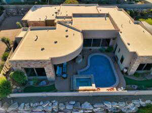 View of subject property featuring a pool