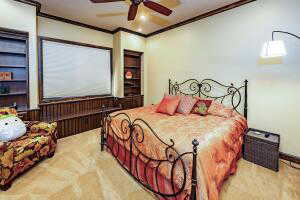 Bedroom with crown molding and a ceiling fan