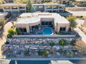 Aerial view of property and surrounding area featuring a pool