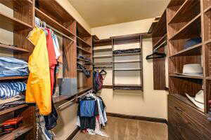 Spacious closet with light wood finished floors
