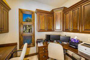 Office space featuring built in study area and baseboards