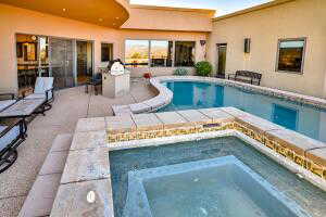 Swimming pool featuring an in-ground hot tub and a patio