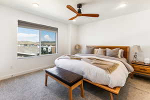 Carpeted bedroom featuring ceiling fan and recessed lighting