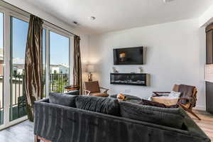 Living area featuring light wood-style flooring and a textured ceiling