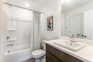 Full bathroom with shower / tub combo, vanity, and tile patterned floors