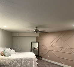 Bedroom with carpet flooring, a textured ceiling, ceiling fan, and recessed lighting