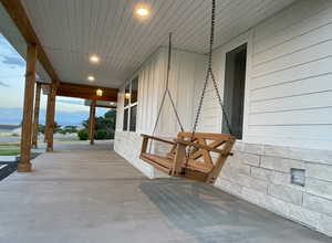 Covered porch featuring a mountain view