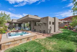 Back of property featuring stucco siding and a patio
