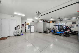 Garage with freestanding refrigerator and electric panel