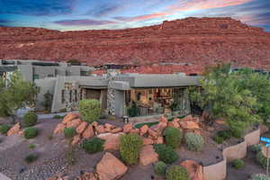 Back of property featuring a patio, a mountain view, and stucco siding