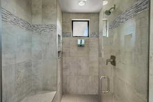 Full bathroom featuring a shower stall