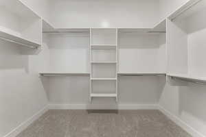 Spacious closet with light colored carpet