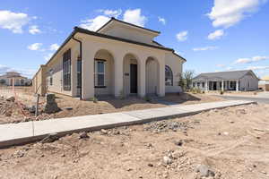 Mediterranean / spanish home featuring covered porch and stucco siding