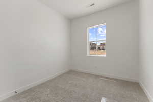 Unfurnished room with light carpet and baseboards