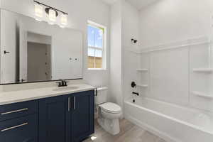 Full bath featuring  shower combination, vanity, and light wood-type flooring