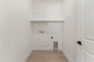 Laundry room with hookup for a gas dryer, light wood-style floors, hookup for an electric dryer, and washer hookup