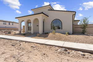 Mediterranean / spanish-style home featuring stucco siding and a porch