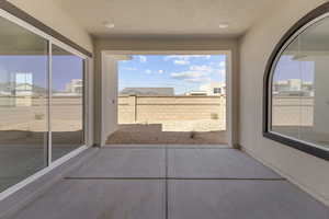 Unfurnished sunroom with plenty of natural light and a textured wall