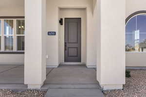 View of exterior entry with stucco siding