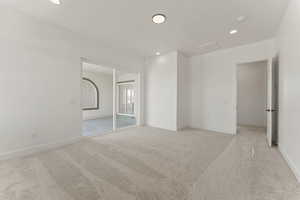 Spare room featuring light carpet and recessed lighting