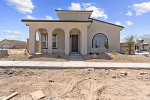 Mediterranean / spanish house with a porch and stucco siding