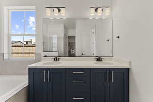 Bathroom with double vanity, a bath, and a walk in shower