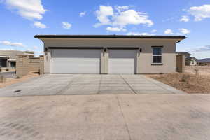 Garage featuring concrete driveway
