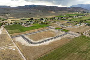 Aerial view of property and surrounding area with mountains and rural landscape