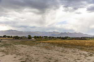 View of mountain backdrop featuring rural landscape