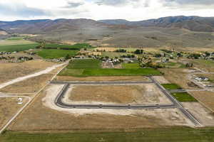 Aerial view of property's location with a mountain backdrop and rural landscape