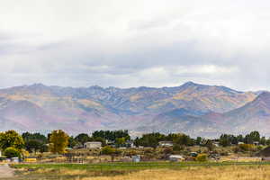 View of mountain backdrop with rural landscape
