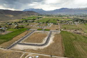 Aerial overview of property's location featuring a mountain backdrop and rural landscape