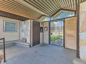 Property entrance featuring a patio and stone siding