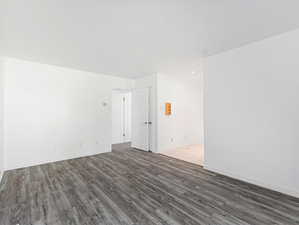 Unfurnished room with wood finished floors and baseboards