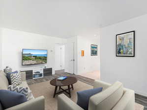 Living area featuring baseboards and wood finished floors