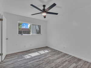 Unfurnished bedroom with light wood finished floors and a ceiling fan