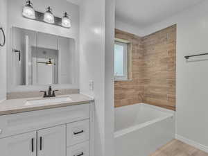Bathroom with vanity, light wood-type flooring, and ceiling fan