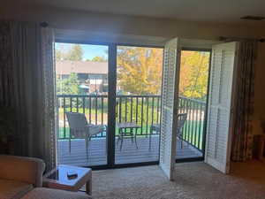 Doorway to outside featuring carpet