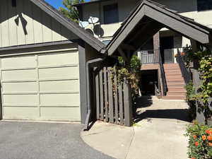 View of exterior entry featuring an attached garage