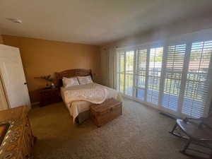 Carpeted bedroom featuring access to outside