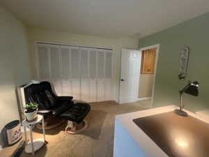 Sitting room featuring light colored carpet and baseboards
