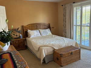 Carpeted bedroom with access to exterior