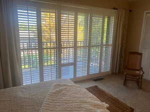 Carpeted bedroom featuring access to outside