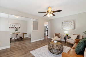Living area featuring wood finished floors and ceiling fan